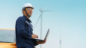 asian man working on a wind turbine project
