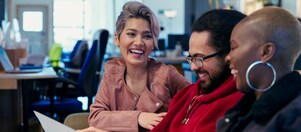 Laughing creative business people working in office