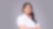 Zahira smiling with hand cross looking at camera wearing white Shell corporate shirt