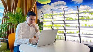 An employee at office looking into his laptop screen.