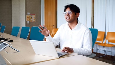 Hakim's talking to someone while he is at his laptop simultaneously working.