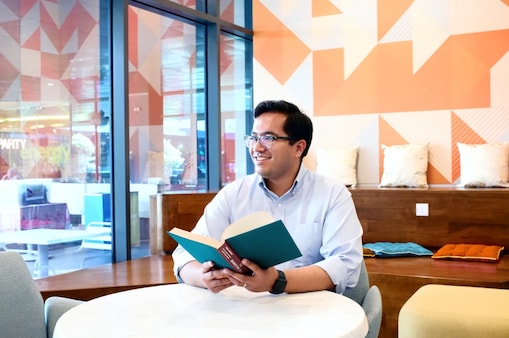 Aflah takes a minute and looks away from the book he is reading.