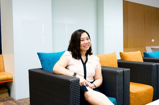 Ching taking a break at office as she sits and rests a bit.