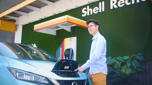 Daniel charging his electric car at Shell charging station at office.
