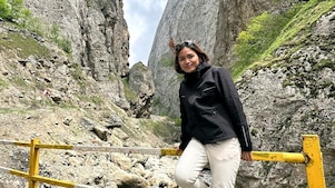 An engineer posing in front of a mountain during her vacation