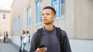 a male student wearing a backpack. 