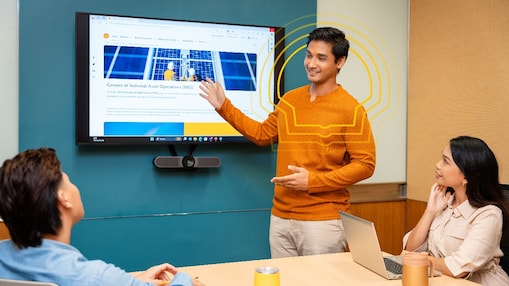 group of three employees in a discussion in a meeting room