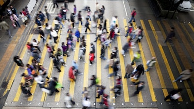 People cross a busy street in Hong Kong