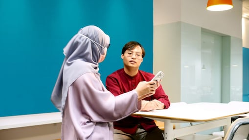 An employee at office looking into his laptop screen.
