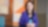 Simren smiling while look elsewhere with a closed coffee mug in front of her.