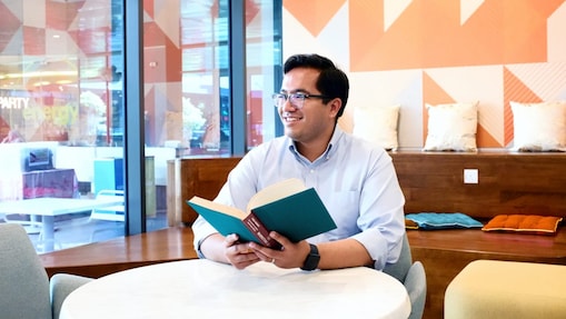 Aflah takes a minute and looks away from the book he is reading.