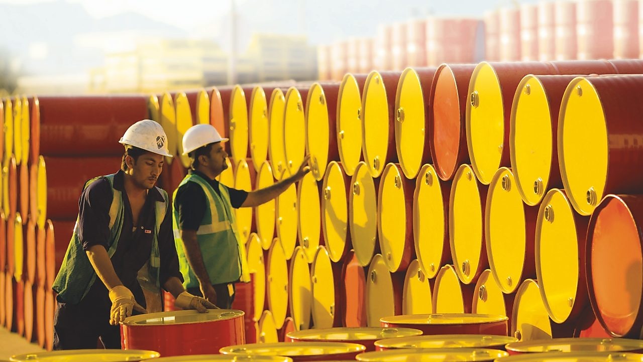 two employees transporting Shell barrels