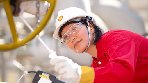 female employee inspecting equipment