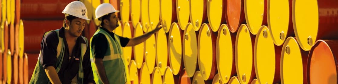 two employees transporting Shell barrels