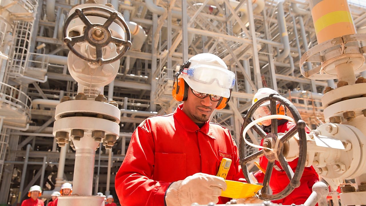 worker checking a valve