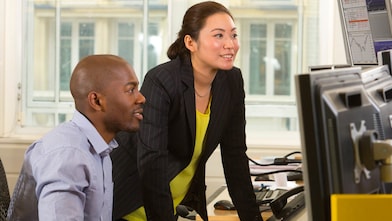 Employees looking at a computer screen