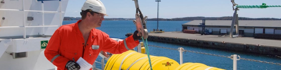 Employee inspectring equipment on a docked boat