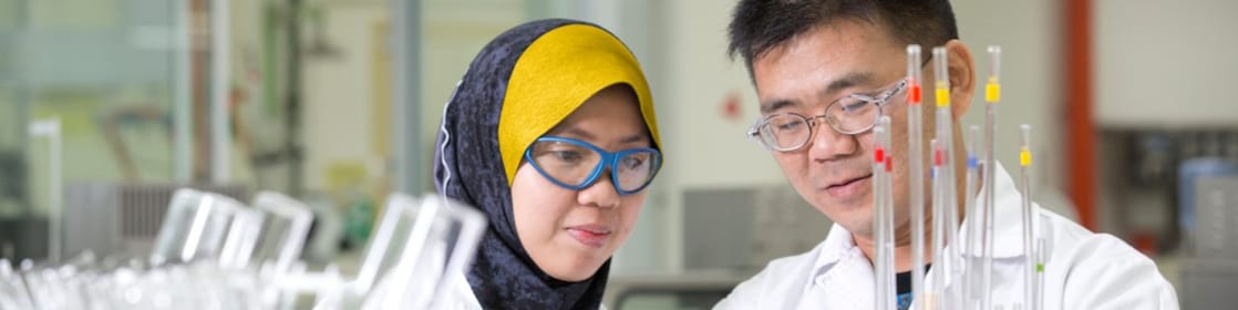 Two employees working in a production lab