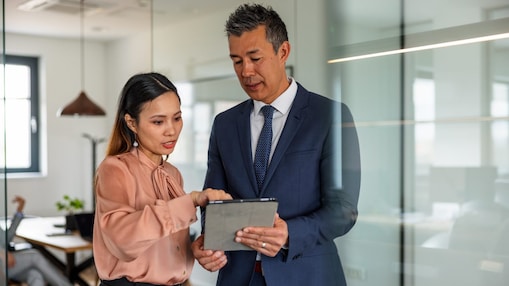 Two people studying a file