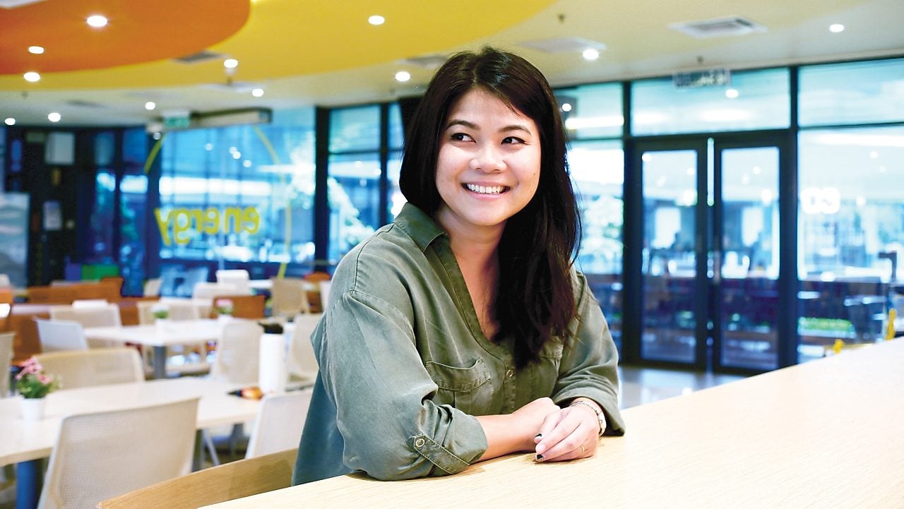 A woman buying online with her card through her I pad while  at work.