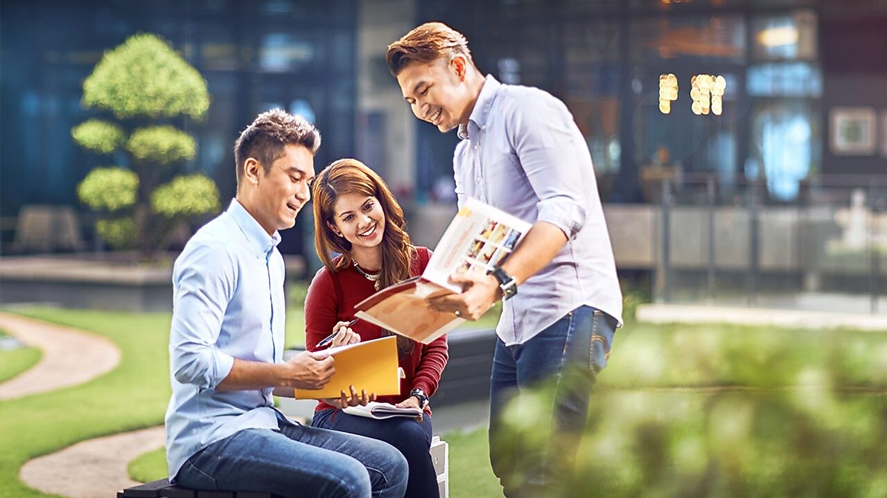 two colleagues discussing about a file