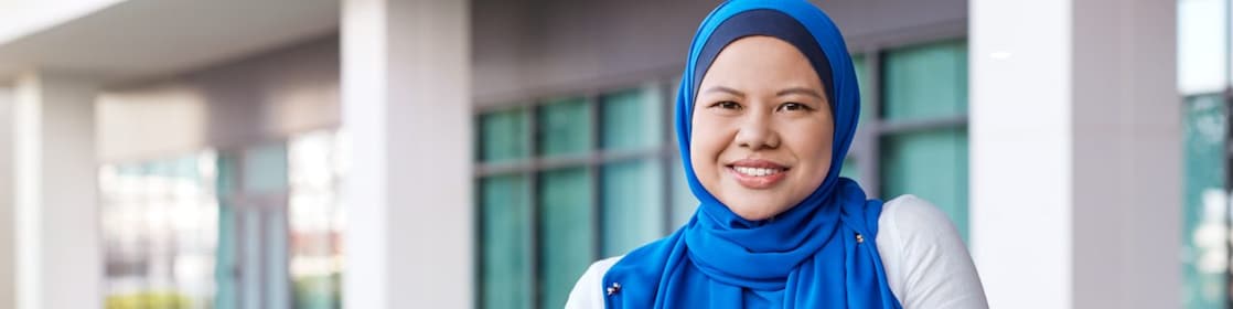 Maria posing in front of a building