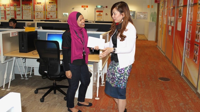 Maria discussing work with Siti Sulaiman, GM Global Operations Commercial Services (GOCS)