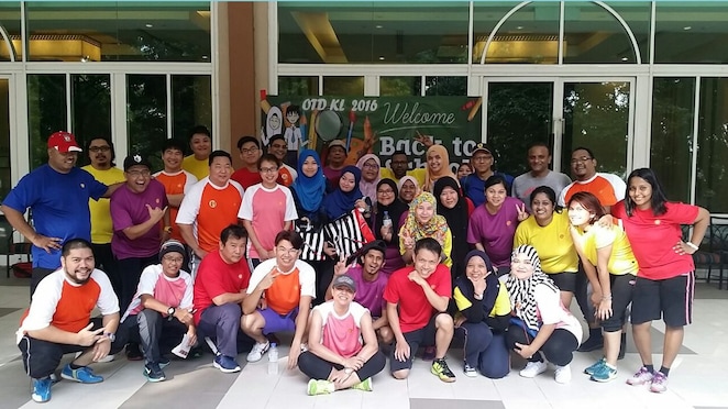 Maria in her zumba class standing with her Zumba class team