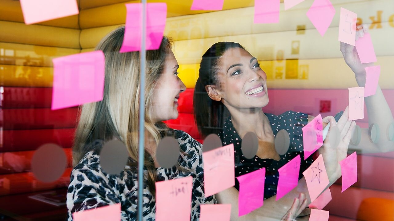 Female workers discussing work in dymanic work environment