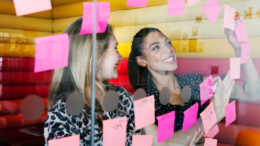 Female workers discussing work in dymanic work environment