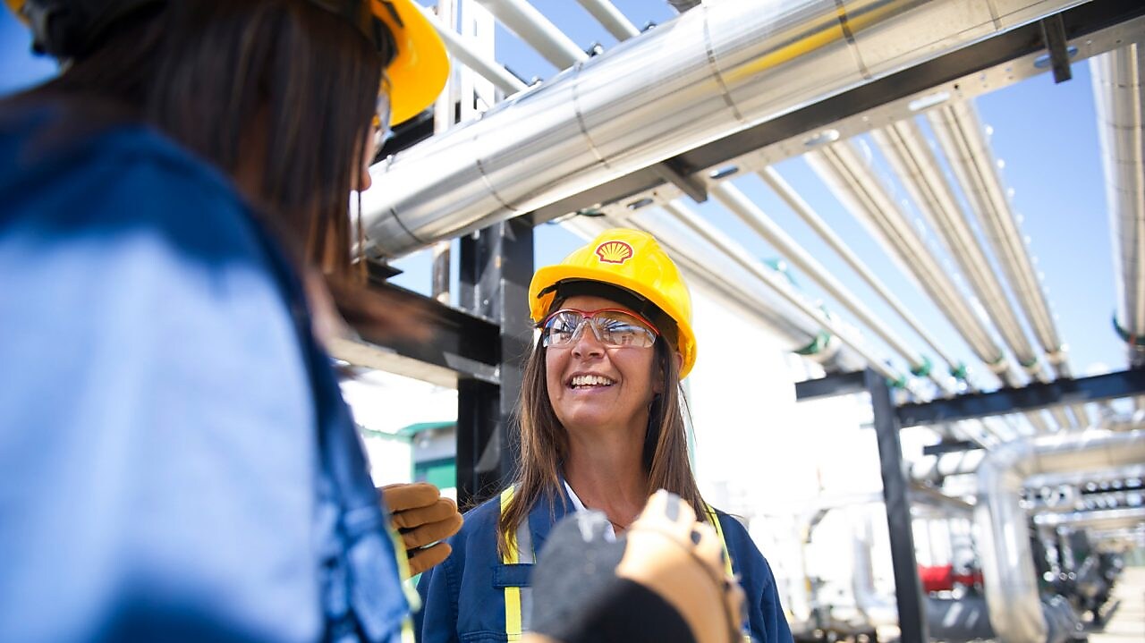 Female colleagues on site talking and smiling