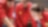 three people looking at plans red uniforms