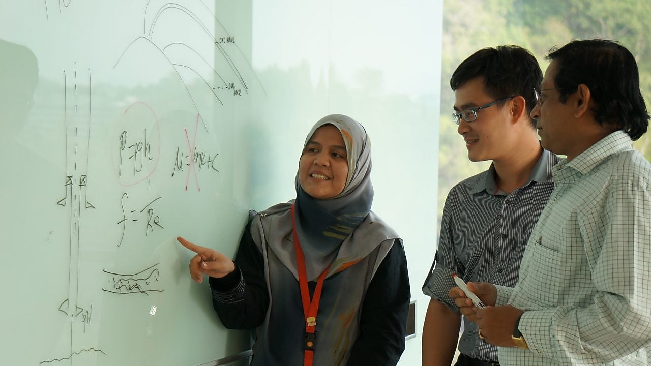 Musfirah Musa discussing work with collagues