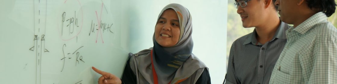 Musfirah Musa discussing work with collagues