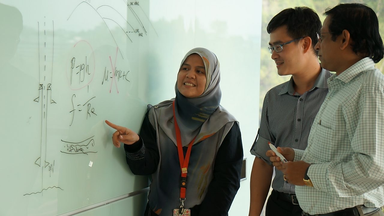 Musfirah Musa discussing work with collagues