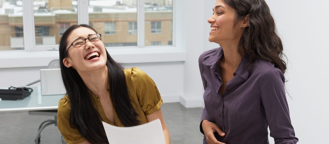 Businesswomen laughing in office