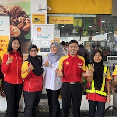 Dato Amilia with her daughter (third from left) and staff