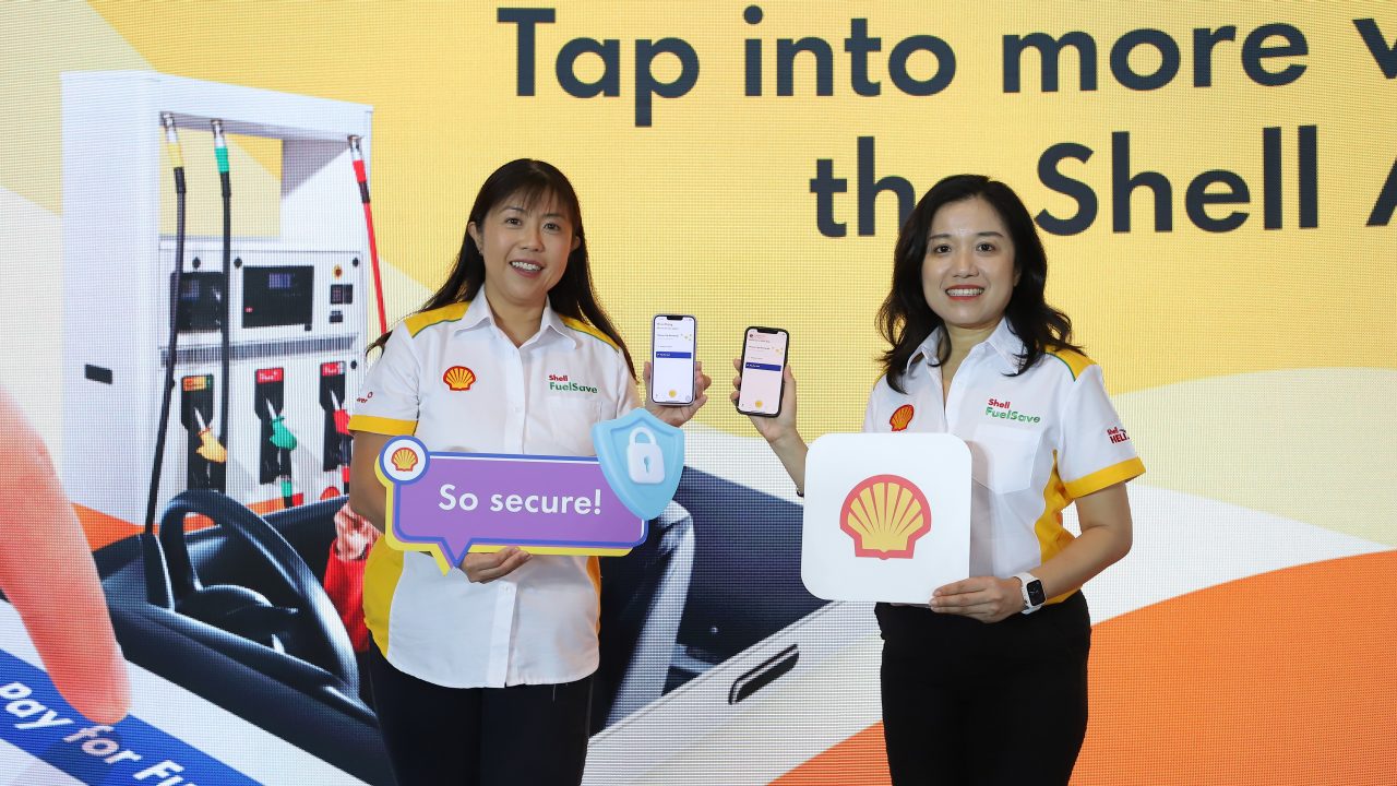 Women holding phone that showcase Shell App during media launch
