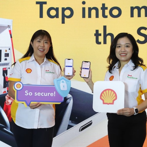 Women holding phone that showcase Shell App during media launch