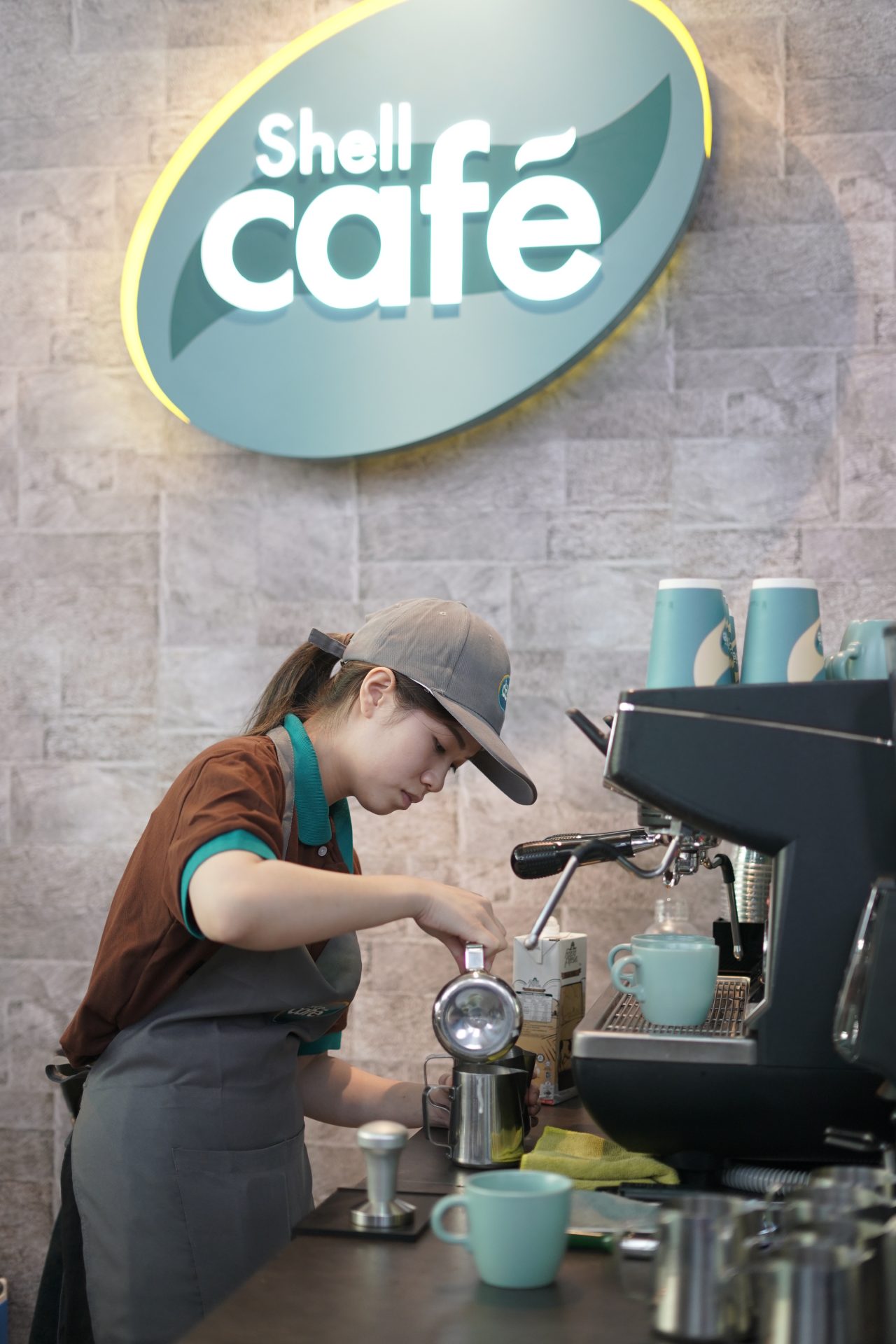 A Women makeing cofee at shell cafe