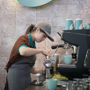 A Women makeing cofee at shell cafe