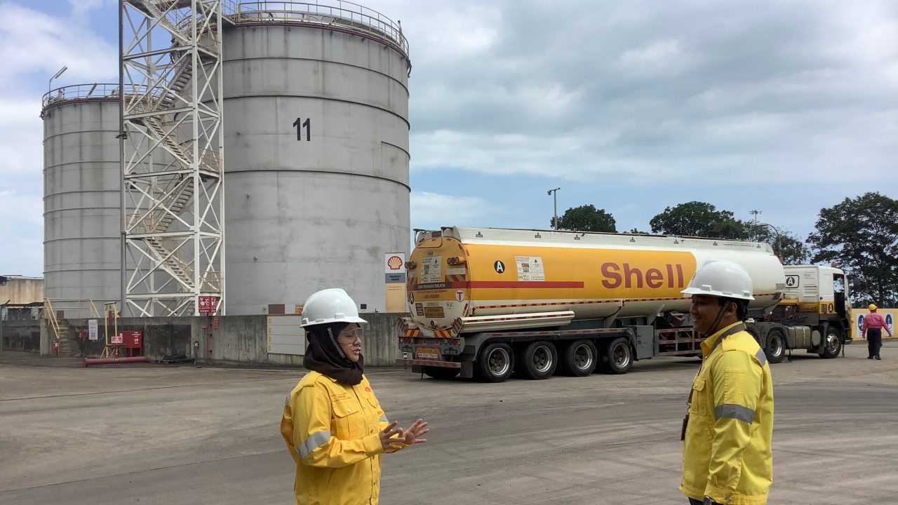 Faridah in discussion with her staff in one of Shell-s terminals