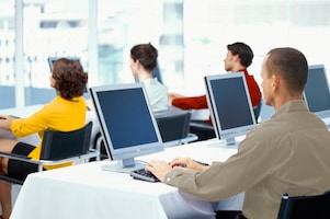 People working and looking at computer monitors