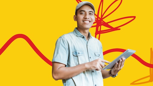 Young male entrepreneur smiling while holding an Ipad standing in front of the Shell LiveWIRE Malaysia 2022 graphical background