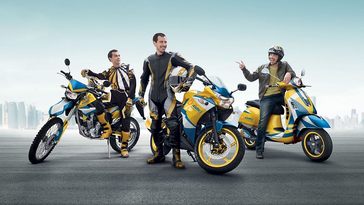Three men with Shell Advance motorcycles