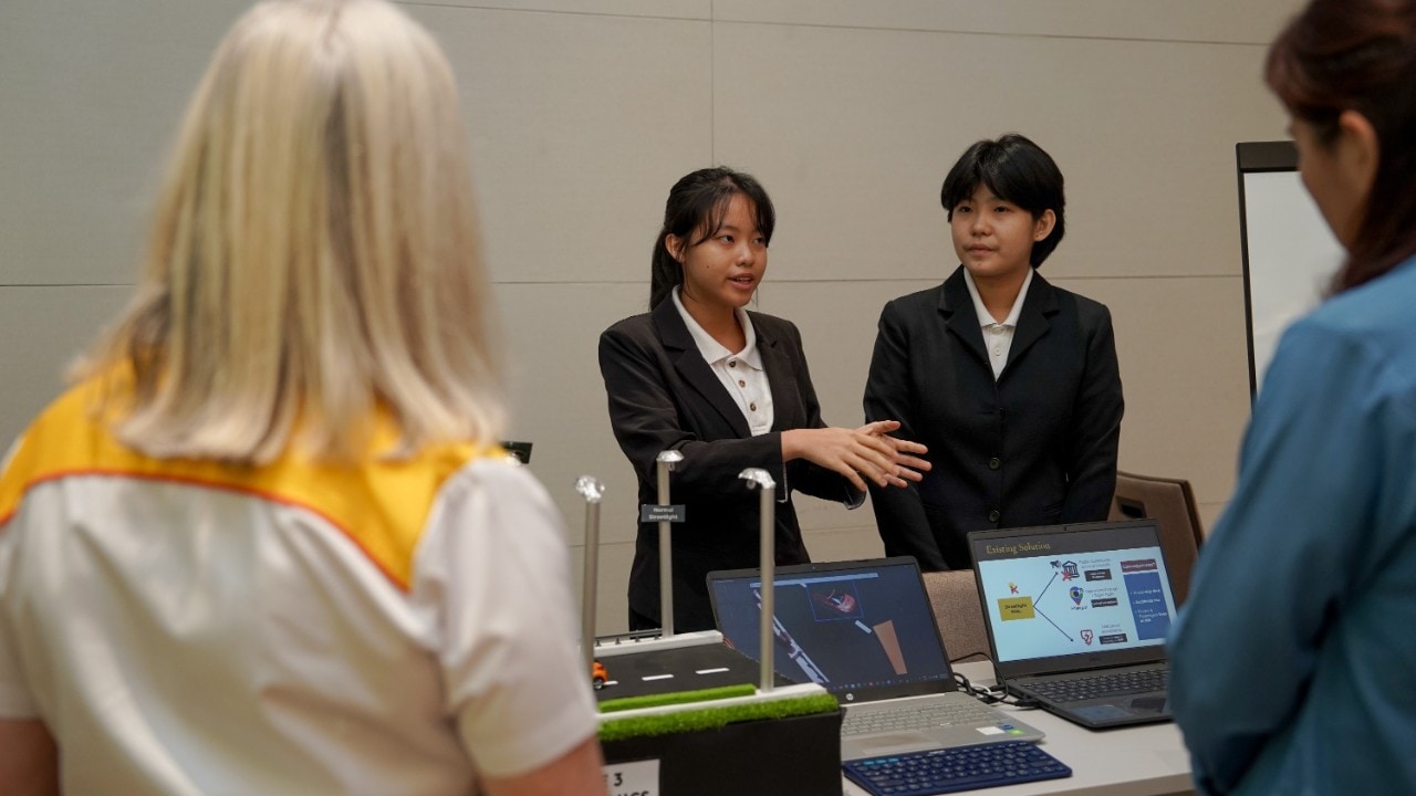 Team The 3 Mechanics presenting their project to the judging panel at the Shell NXplorers Malaysia National Final.