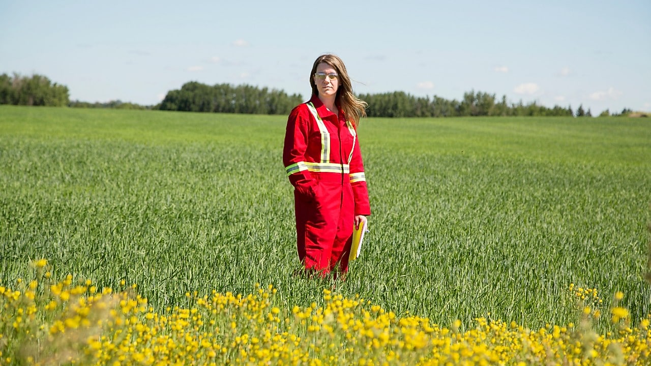 An employee stands in a field near a Quest C02 injection well northeast of Edmonton, Alberta in Canada