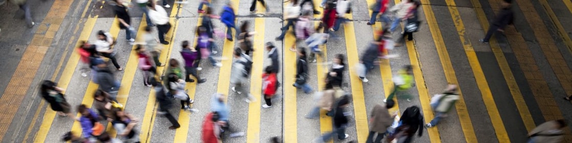 People cross a busy street in Hong Kong
