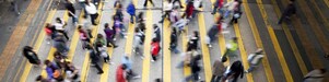 People cross a busy street in Hong Kong