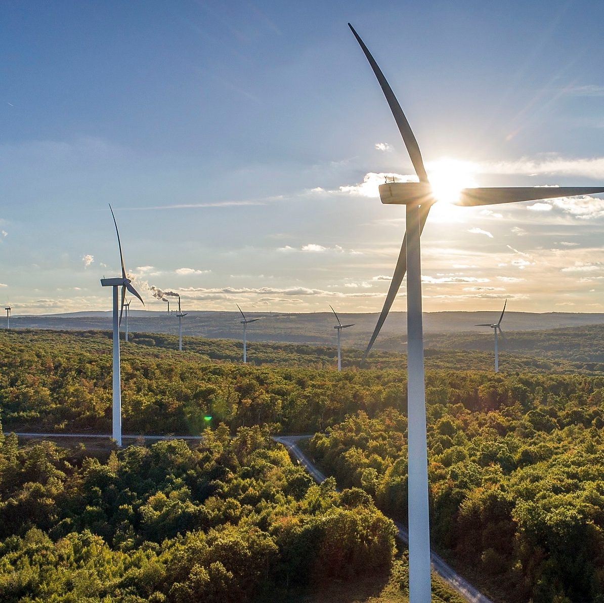Wind Turbine Generators on a mountain in the setting sun.